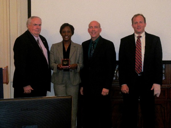 Kameke Mitchell accepts her Emerging Leader Award in February from Tom Gwaltney (l), regional vice president for the Mid-South Region; Robert Shofner (2nd from r), program executive officer for Business and Enterprise Systems, Maxwell Air Force Base; and Dr. Joe Besselman, chapter president.